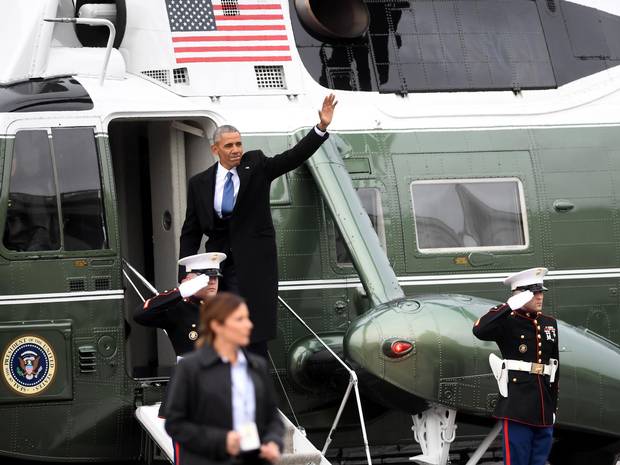 Mr. Obama waves as he boards a helicopter to depart the U.S. Capitol after the inauguration.