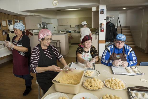 Emma Galang, Elenita Ajusto, Margaret Kluzinski, and Lee-Ann Kluzinski of the Perogy Pinchers work in the basement of St. Gerard Parish.