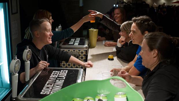 Bartenders Faith McGregor, left, and Katie Brunke serve customers at an event put on by the Society of Beer Drinking Ladies in Toronto on Sept. 30.