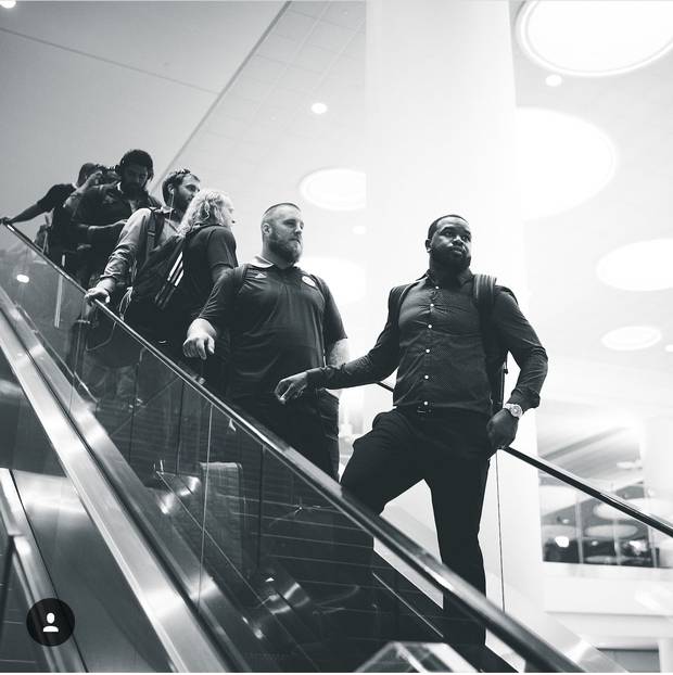 The Toronto Argonauts descend an escalator at the Winnipeg airport.
