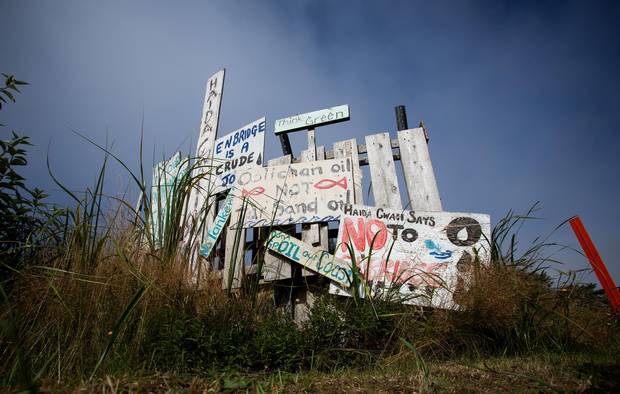 Handmade anti-pipeline signs are seen on the side of a road in the First Nations village of Old Massett, B.C.