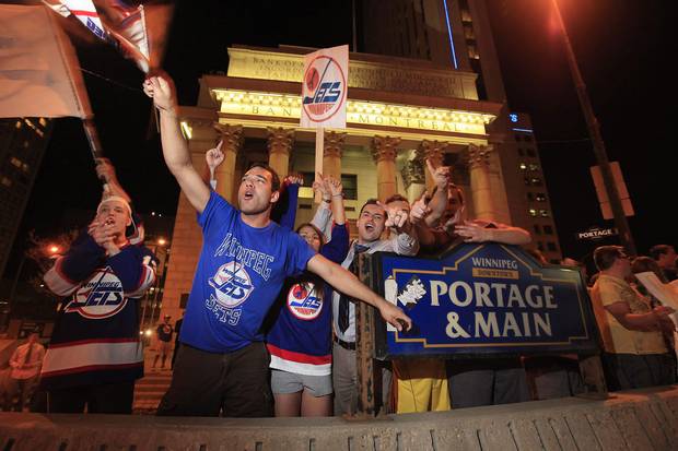 2011: Hockey fans celebrate at Portage and Main after reading a report in The Globe and Mail that an NHL team maybe returning to Winnipeg.