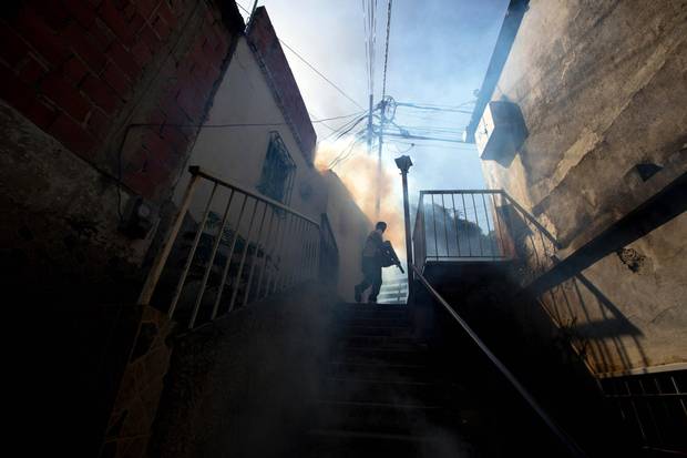 A municipal worker fumigates for Aedes aegypti mosquitoes that transmit the Zika virus in Caracas in 2016. Upon news of the outbreak of CZS cases in Brazil, the rest of the Americas, including Venezuela, braced for a disaster that never came. 