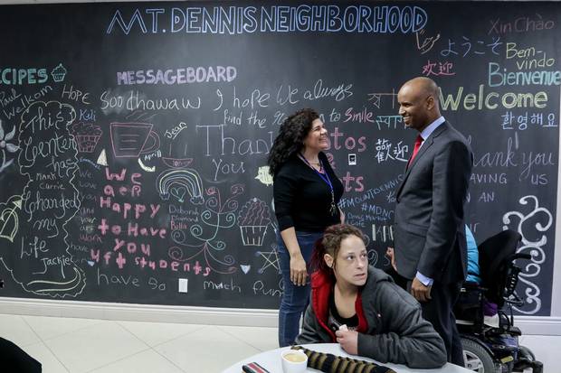 Mr. Hussen talks with Cecilia Ortega of the Mount Dennis Neighbourhood Centre.