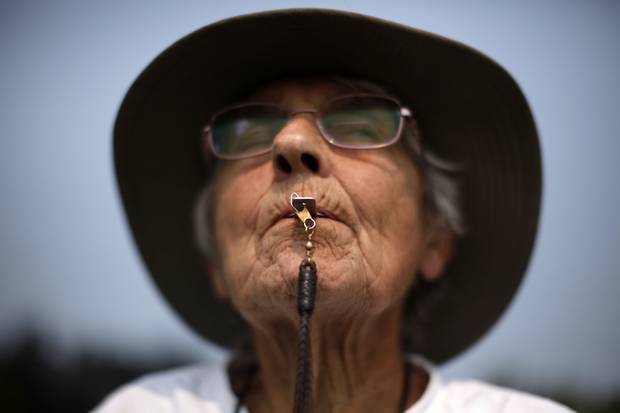 Daphne Tomblin uses a shepherd's whistle to help instruct her border collie.
