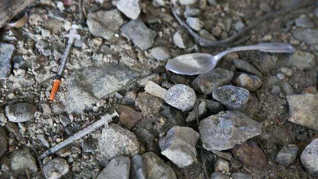 Needles scattered along the ground in a homeless encampment in Lawrence, Mass., on March 12, 2016.