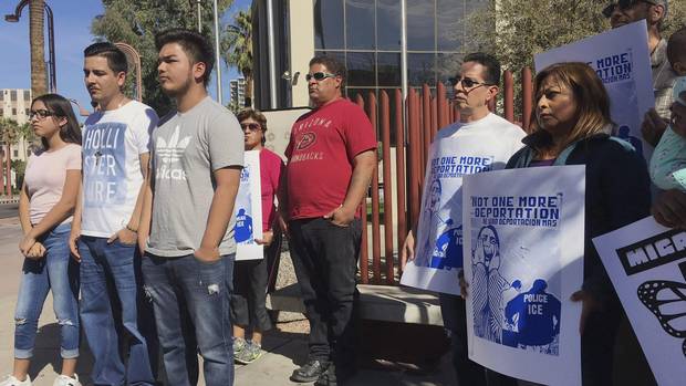 Members of the family of Guadalupe Garcia de Rayos, left, stand with supporters at a news conference in front of the U.S. Immigration and Customs Enforcement office in Phoenix.