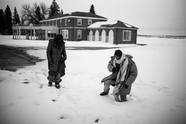 Lul Abdi Ali and Abdullahi Warsame climb through deep snow at the border.