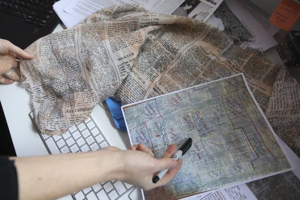 Ms. Pruden printed out a big picture of the scarf and divided it into colour-coded sections to look for clues about where it came from.