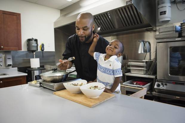 Chef Philman George and his son Zaihman prepare clams in white wine sauce at High Liner Foods in Vaughan, Ontario Saturday June 4/2016.