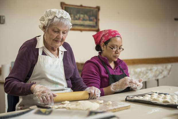 Anna Amborsky and Adda Morales prepare perogies in the basement of St. Gerard Parish.