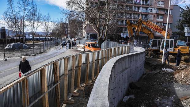 Men stand by bulldozers taking down a concrete wall near the main bridge in the town of Mitrovica on Feb. 5.