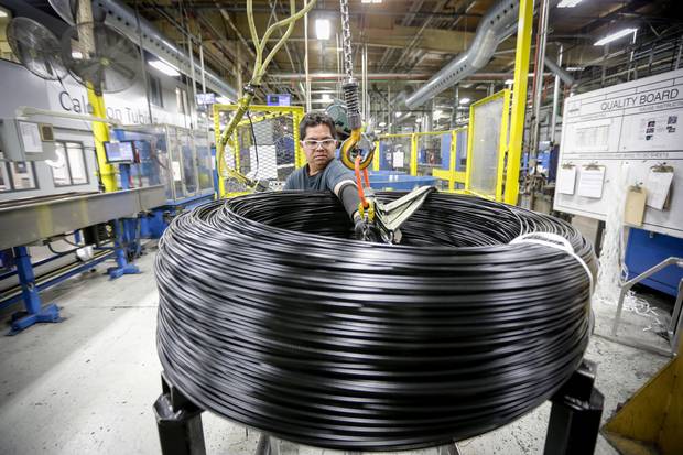 A worker prepares coiled brake lines for shipping to Mexico at the end of the production line at Caledon Tubing – a division of Martinrea International – in St. Marys, Ont., in 2016.