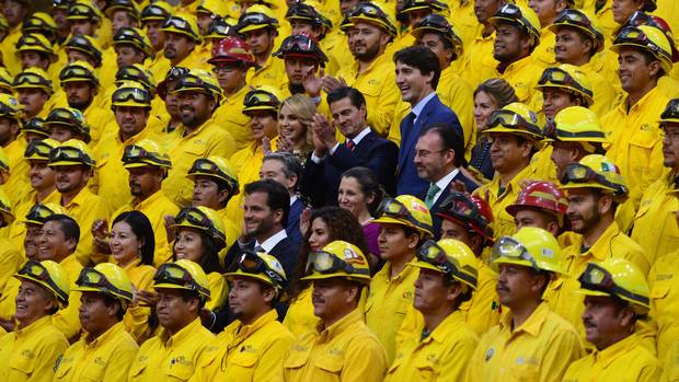 At the news conference, Mr. Trudeau, Mr. Pena Nieto, their wives and ministers take part in a photo op with Mexican firefighters, who helped to fight Canadian forest fires.