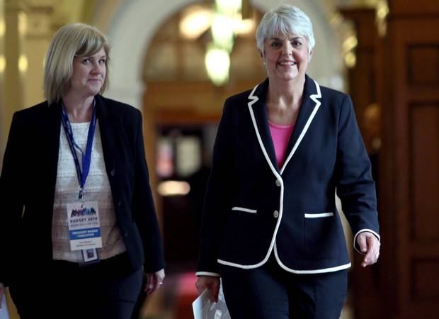 B.C. Finance Minister Carole James (right) arrives at caucus with a ministry staff member before delivering the provincial budget on Feb. 20, 2018.