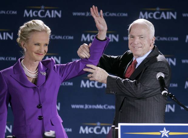 Republican presidential hopeful Sen. John McCain lifts his wife's arm up as the two take the stage at an election night watch party at The Citadel, in Charleston, South Carolina in Jan. 2008 following primary voting in South Carolina.