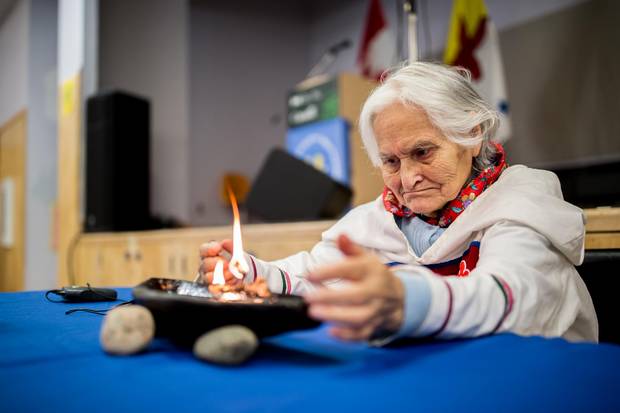 Elisapee Ootova, Jena Merkosak's grandmother, lights a qulliq before the announcement of the new protected area of Lancaster Sound.