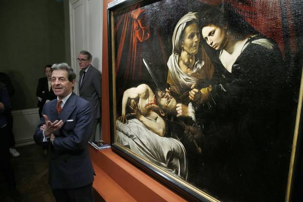French painting expert Eric Turquin speaks on April 12, 2016 in Paris in front of the painting entitled 'Judith cutting off the head of Holofernes', presented as being painted by Italian artist Caravaggio (1571-1610).
