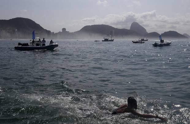 Richard Weinberger of Canada takes part in the international marathon swimming event in Copacabana in Rio de Janeiro, Brazil, last summer. Triathletes will be swimming the polluted waters at the Olympics this summer.