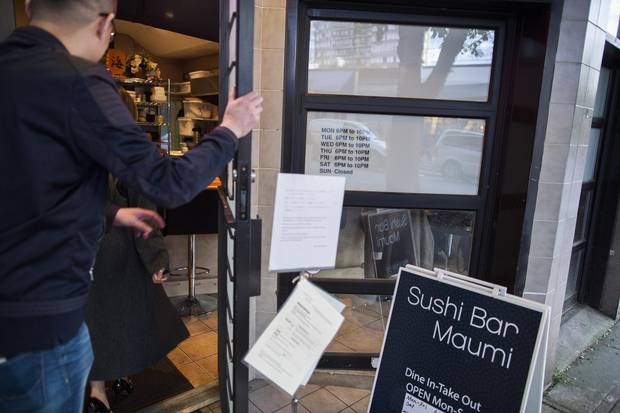 Customers arrive at Sushi Bar Maumi in Vancouver.