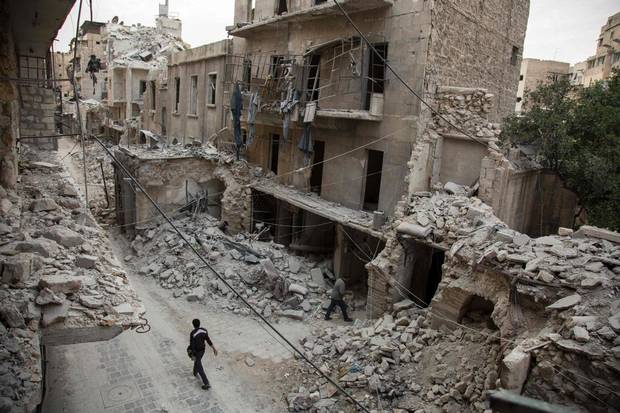 A Syrian man walks past destroyed buildings on May 2, 2016, in Aleppo's Bab al-Hadid neighbourhood which was targeted recently by regime air strikes. Aleppo residents ventured out onto the streets, taking advantage of a lull in violence in the northern Syrian city as the United States pushed to salvage a ceasefire.