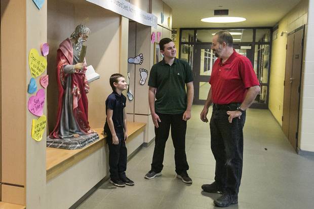 Andrew Bienhaus (right), who is not Catholic, has two sons attending Catholic schools. Connor (left), 9, attends St. Matthew Catholic Elementary in Binbrook while Sean (centre), 15, attends Bishop Ryan in Hamilton.