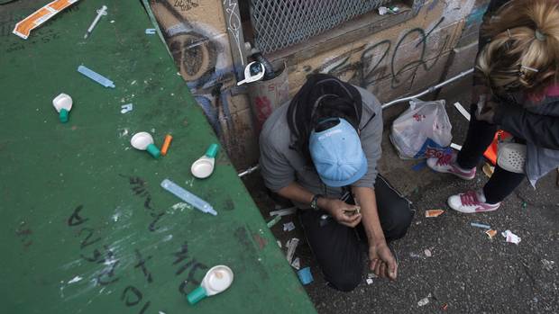 A drug user injects in Vancouver's Downtown Eastside.