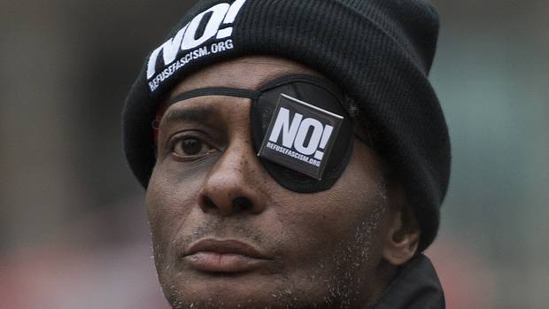 A protester marches during a rally against President-elect Donald Trump in McPherson Square in Washington DC, on January 17, 2017.