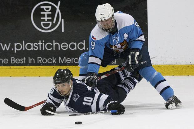 Oxford's Jordan Ho (10) is checked by Cambridge's Vaclav Bernaek (9) during a hockey game on March 3, 2018.