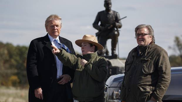Interpretive park ranger Caitlin Kostic, center, gives a tour near the high-water mark of the Confederacy at Gettysburg National Military Park to Donald Trump, left, and campaign CEO Steve Bannon, Saturday, Oct. 22, 2016, in Gettysburg, Pa.