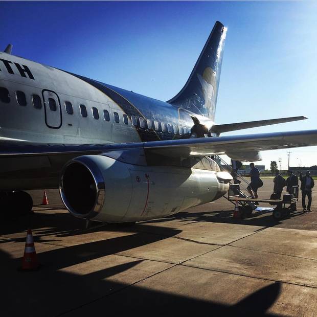 The Edmonton Eskimos board a plane.