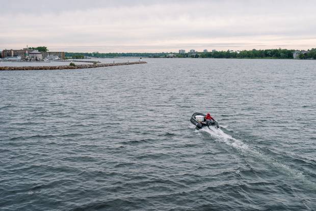 A zodiac from Canada C3 heads toward Kingston’s Confederation Basin Marina.