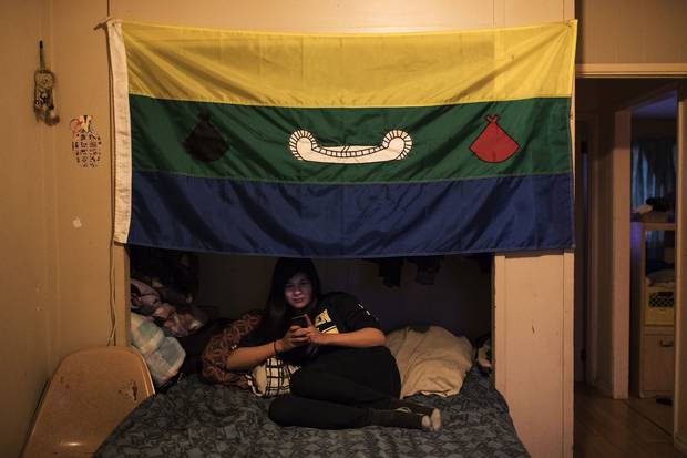 The flag of Marleah’s First Nation, Eabametoong, hangs over her bed. Marleah says that she spends most of her evenings on her phone inside her bedroom. Her best friend, Titanice, lives an hour away, so Marleah is often alone.