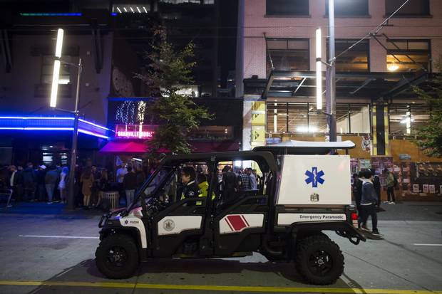 Paramedics on a utility vehicle sit on Granville Street.