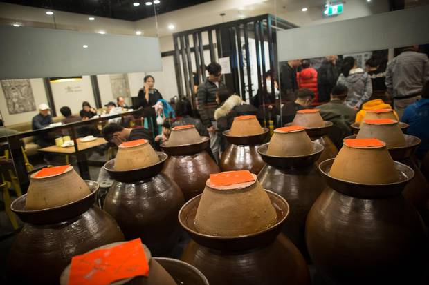 Clay pots containing pickled mustard greens.