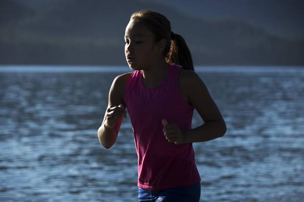 Samara Swan, 11, runs through the Pacific Ocean to train for tack and field on the beach near her home, in Ahousaht, on Flores Island in Clayoquot Sound.