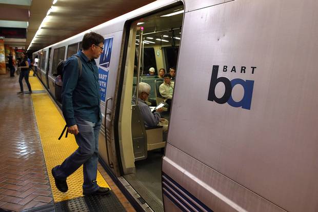A Bay Area Rapid Transit (BART) passenger boards a train on Oct. 15, 2013, in San Francisco. The transit agency is experimenting with reducing the number of seats on some trains.