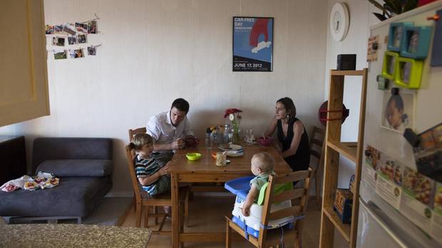 Neil Salmond and Liza Sutton with their children, three-year-old Rafe and seven-month-old Phoebe, at their rental suite in Vancouver.