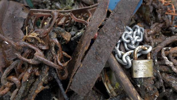 A lock and chain, rusted scrap metal, and a rake are some of the items collected during the Surfrider Pacific Rim Christmas Jingle Cleanup Event along the Tofino harbour shorefront near the 4th Street government dock and marina on Dec. 2, 2016.