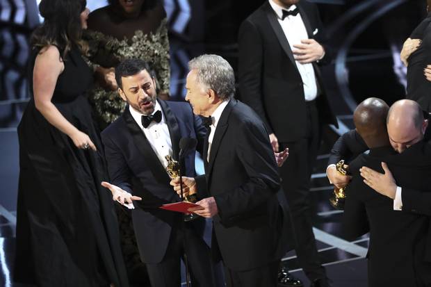 Jimmy Kimmel questions presenter Warren Beatty after he showed the card for Best Picture winner 