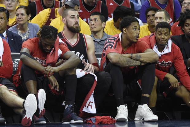 Toronto Raptors forward DeMarre Carroll, left to right, Jonas Valanciunas, DeMar DeRozan and Kyle Lowry look on from the bench during second half.