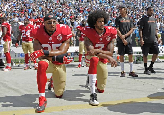 San Francisco 49ers safety Eric Reid, left, and quarterback Colin Kaepernick kneel during the national anthem before an NFL game against the Carolina Panthers in Charlotte on Sunday.