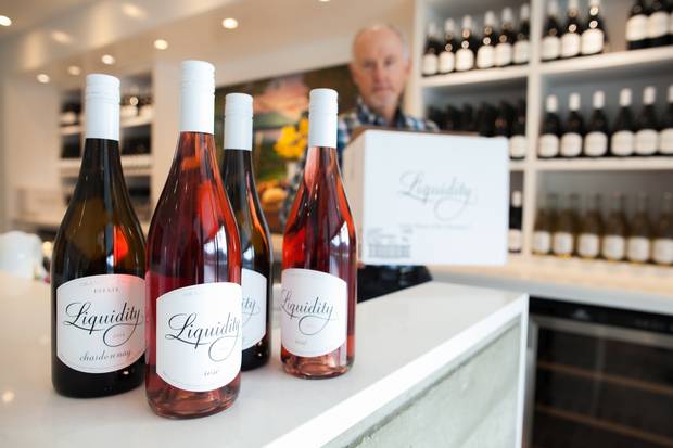 Ian MacDonald, president of Liquidity Wines in Okanagan Falls, B.C., prepares to open the winery's tasting room on Feb. 9, 2018. Alberta's government has announced a ban on B.C. wine imports are part of an escalating fight over Kinder Morgan's Trans Mountain pipeline expansion.