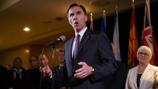 Federal Finance Minister Bill Morneau is flanked by his provincial and territorial counterparts as he speaks during a news conference after reaching a deal to expand the Canada Pension Plan, in Vancouver, B.C., on Monday June 20, 2016.