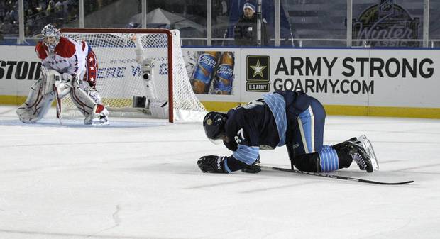 Jan. 1, 2011: The Pittsburgh Penguins' Sidney Crosby crawls on the ice after being injured in the second period of an NHL Winter Classic outdoor hockey game in Pittsburgh.