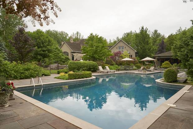 The backyard comes complete with a pool, koi pond and wrought-iron fencing.