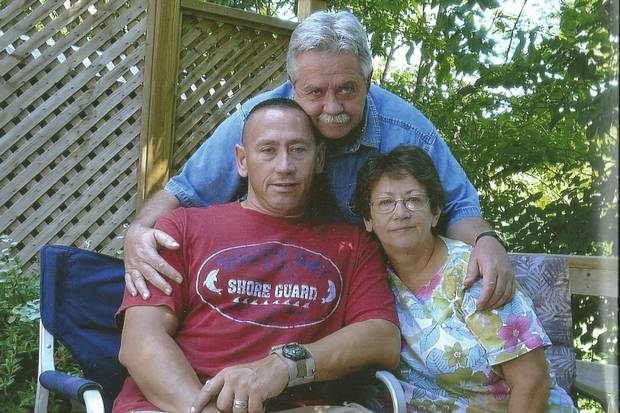 Corporal Tony Reed with his parents, Micheline and Phillip.