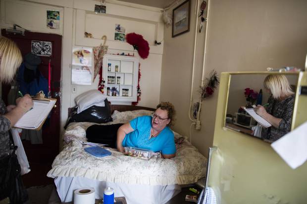 Cindy Bell, left, speaks with Dianne Cooper during her weekly rounds at the Astoria Hotel.