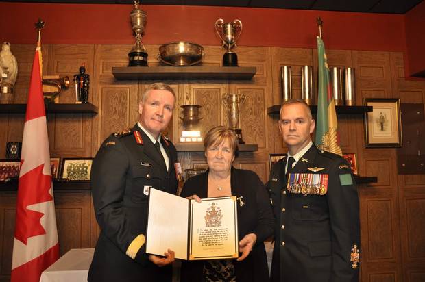 Brigadier-General Stephen Cadden, left, commander of 4th Canadian Division, and Chief Warrant Officer Stuart Hartnell presented the Memorial Cross and Sacrifice Medal to Corporal John Unrau's mother, Dorothy, on Oct. 26 at the Sudbury Armoury. Cpl. Unrau, an Afghanistan war veteran, died by suicide on Canada Day in 2015.
