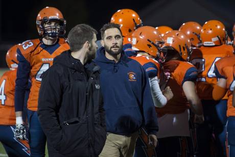 Ecole L’Odyssée Olympiens football head coach Marcel Metti, a paramedic, leaves the huddle before his team’s game on Friday in Moncton.